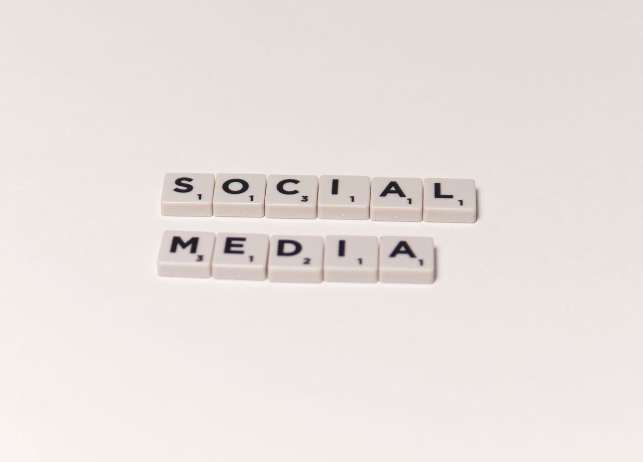 Scrabble tiles arranged to spell social media against a white background, illustrating ideas in digital communication.
